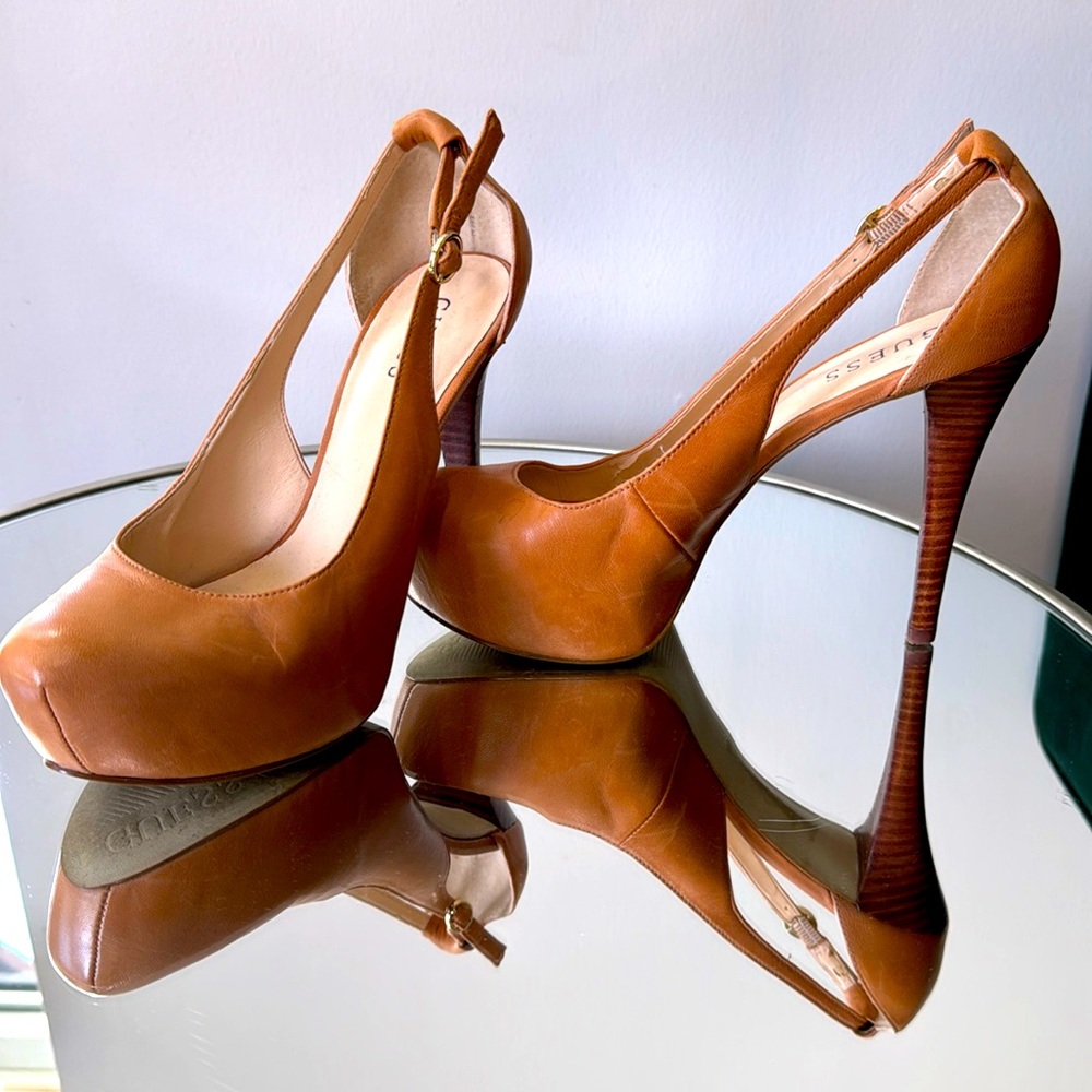 Guess tan platform pumps